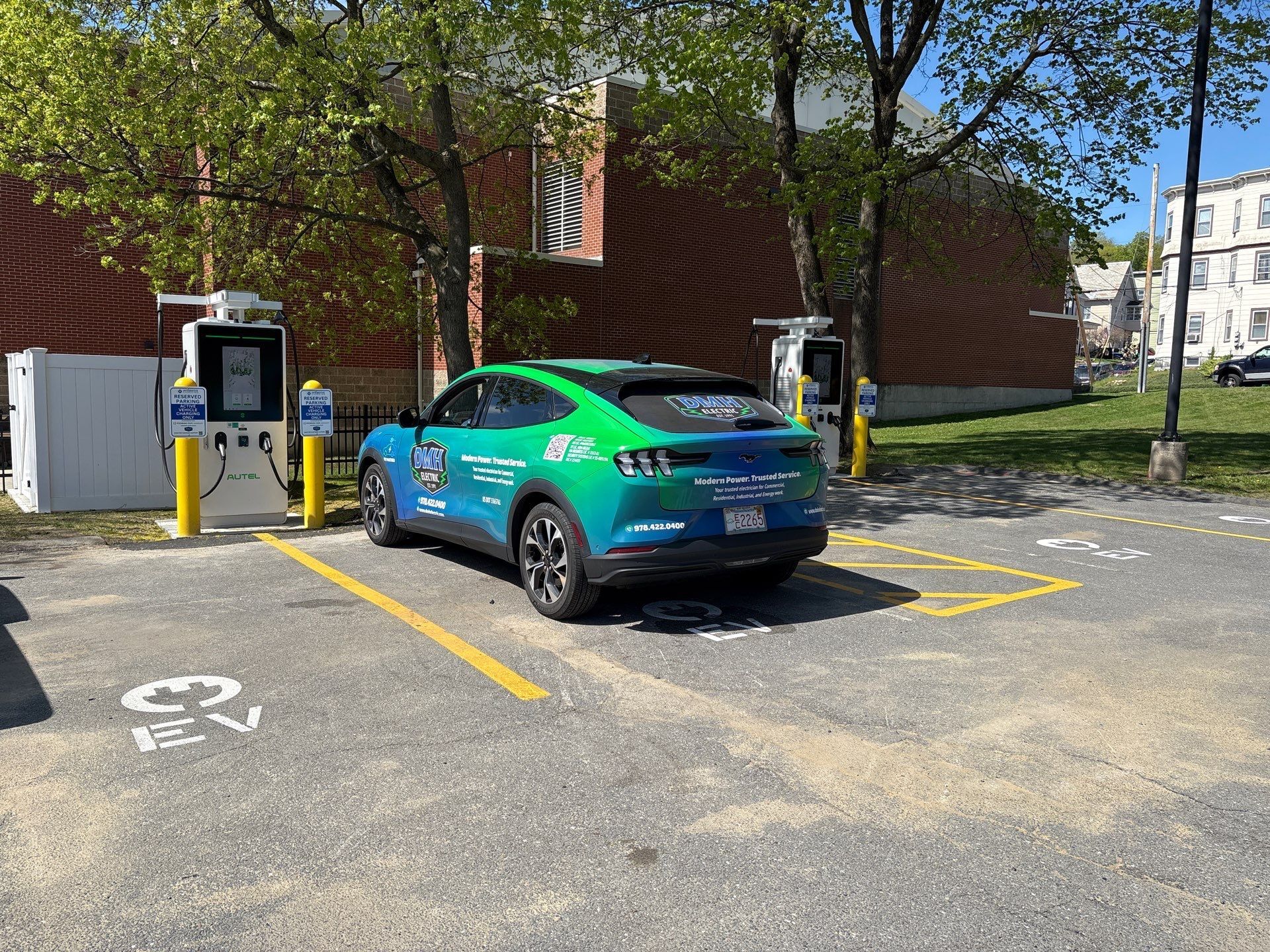 A DMH Electric branded vehicle parked at the new EV chargers